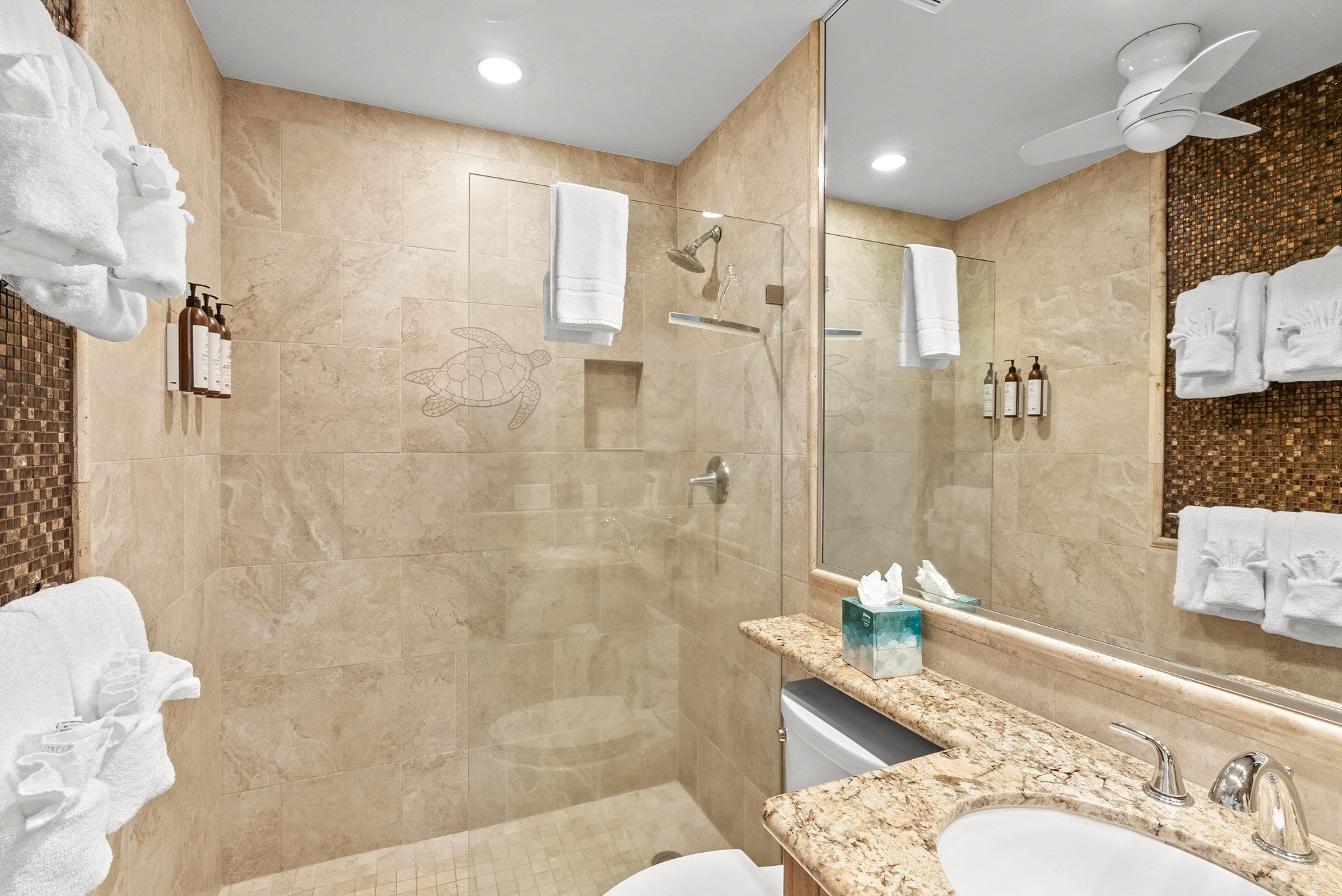 4057 Lower Honoapiilani Road, Unit 114 Lahaina, HI 96761 - Photo 18 of 23 a bathroom with a granite countertop sink a toilet and shower