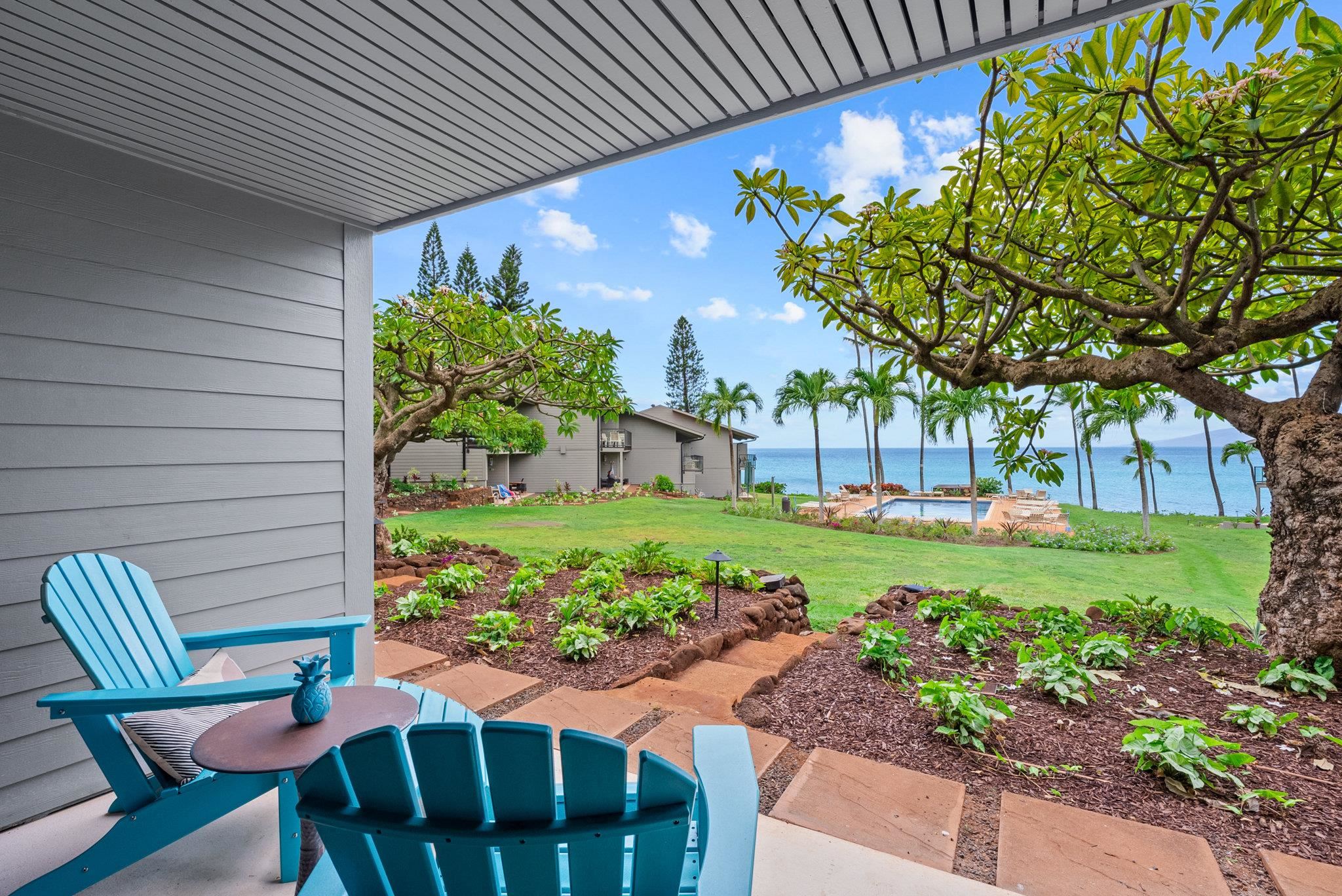 4057 Lower Honoapiilani Road, Unit 114 Lahaina, HI 96761 - Photo 8 of 23 a view of a chair and table in the garden