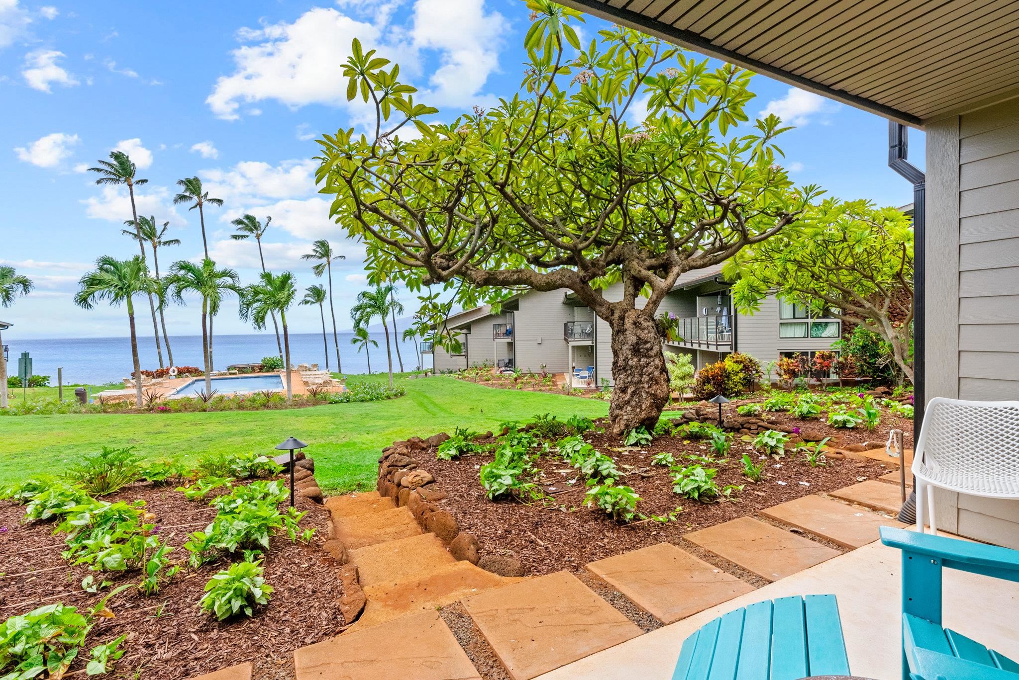 4057 Lower Honoapiilani Road, Unit 114 Lahaina, HI 96761 - Photo 9 of 23 a front view of a house with a yard
