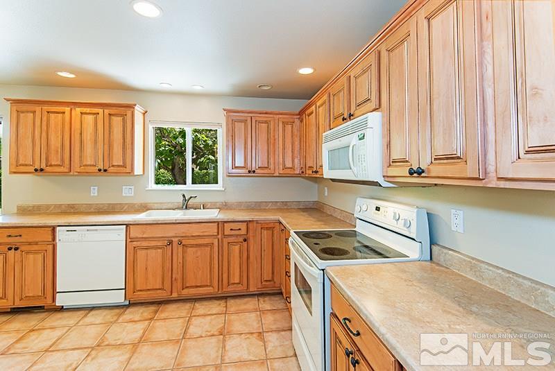 2750 Judith Lane Reno, NV 89503 - Photo 5 of 15 a kitchen with stainless steel appliances granite countertop a stove a sink and a microwave
