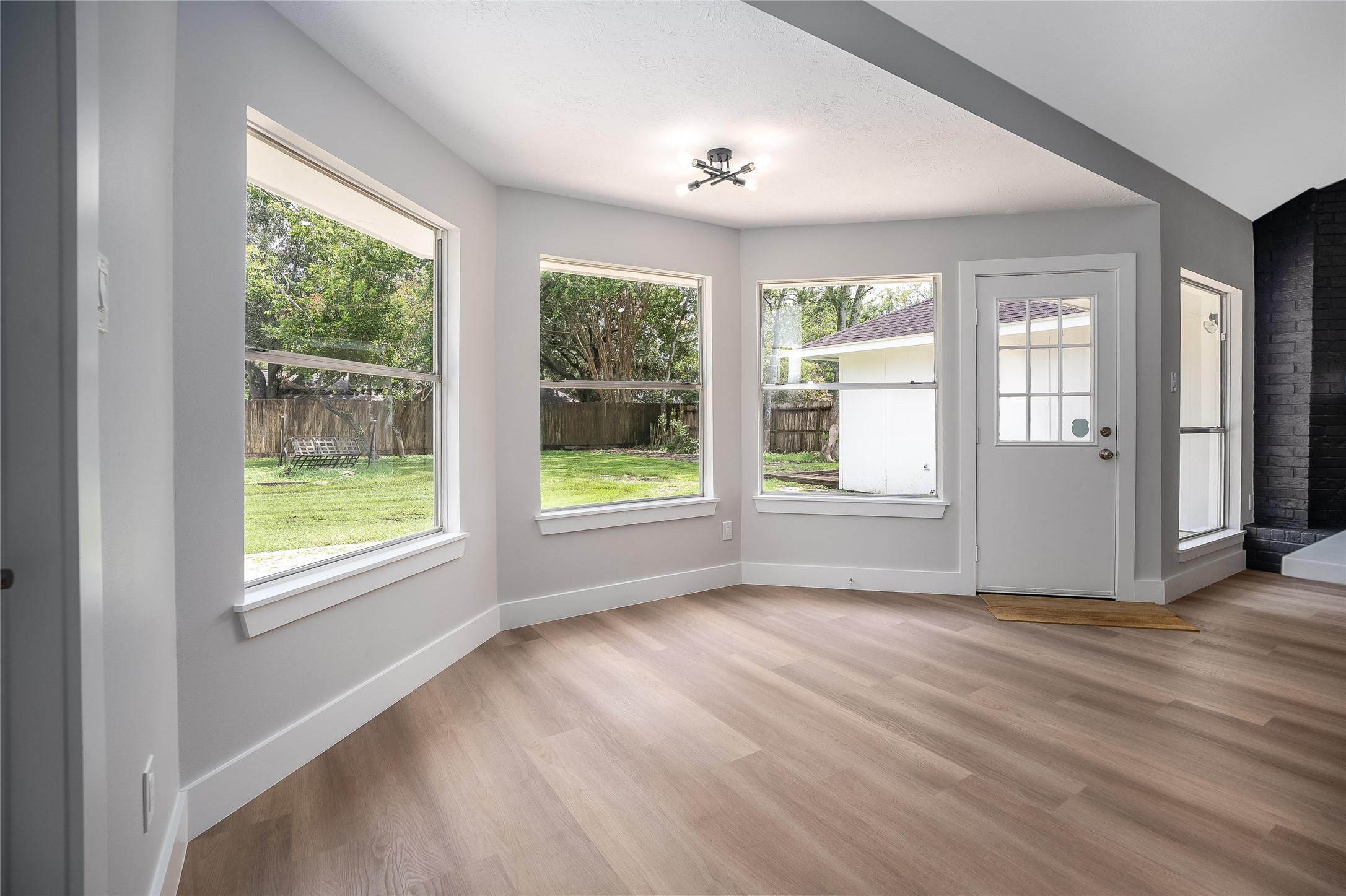 1406 Kent Way Friendswood, TX 77546 - Photo 11 of 31 a view of an empty room with wooden floor and a window