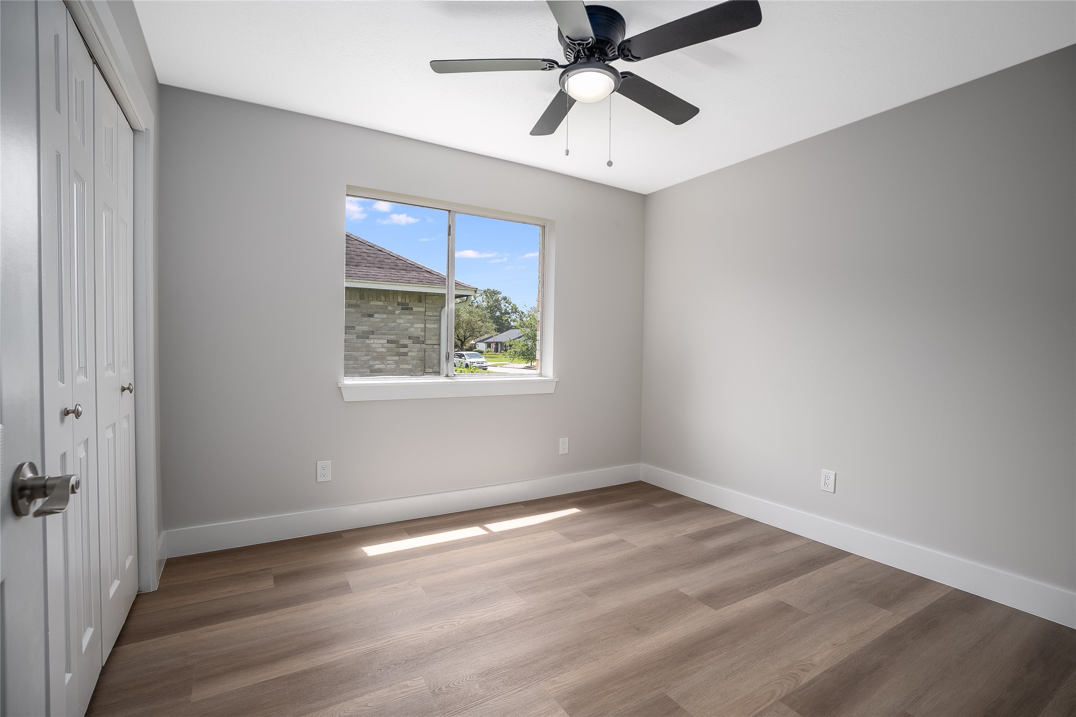 1406 Kent Way Friendswood, TX 77546 - Photo 12 of 31 wooden floor in an empty room with a window