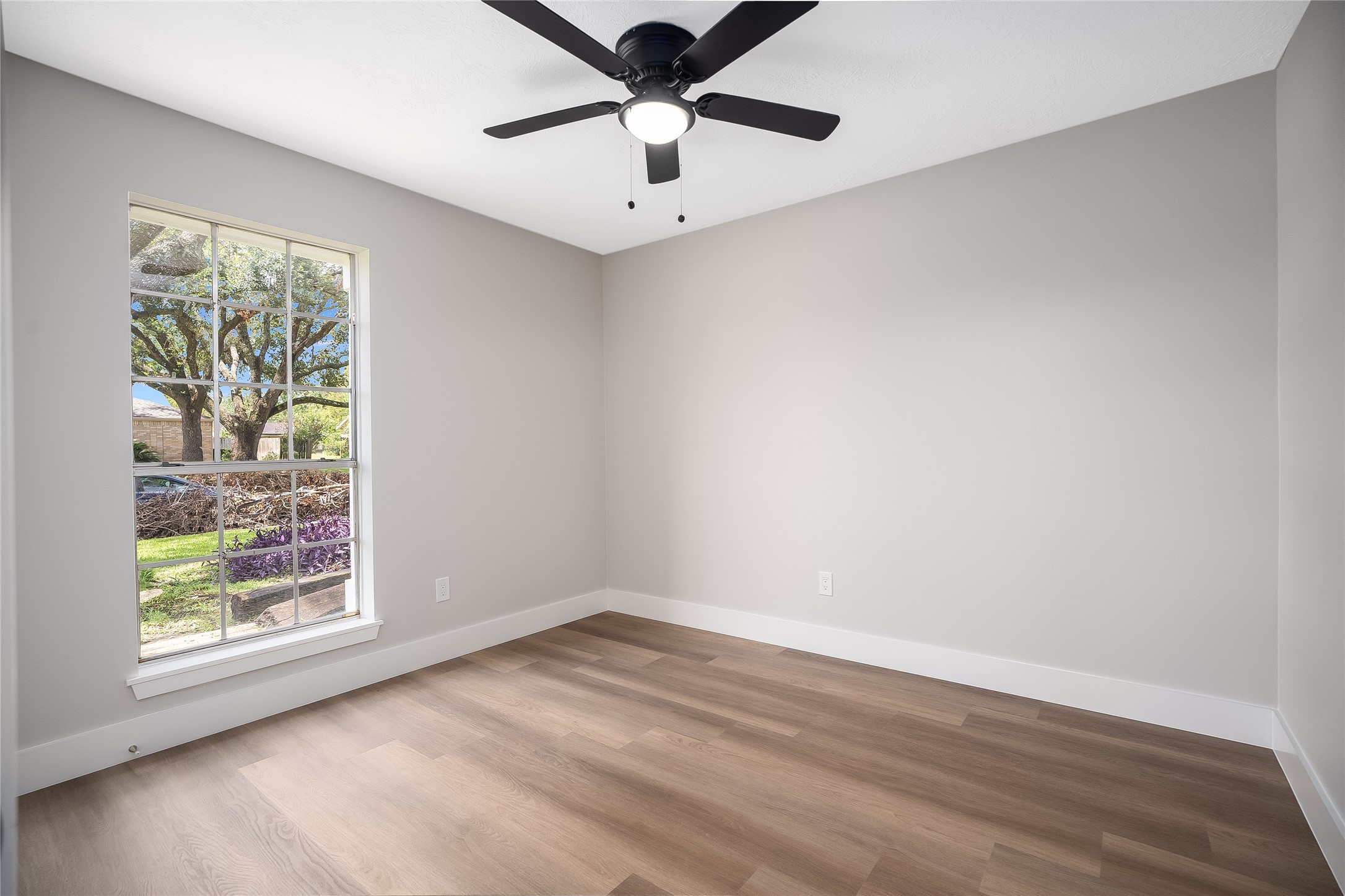 1406 Kent Way Friendswood, TX 77546 - Photo 13 of 31 wooden floor in an empty room with a window