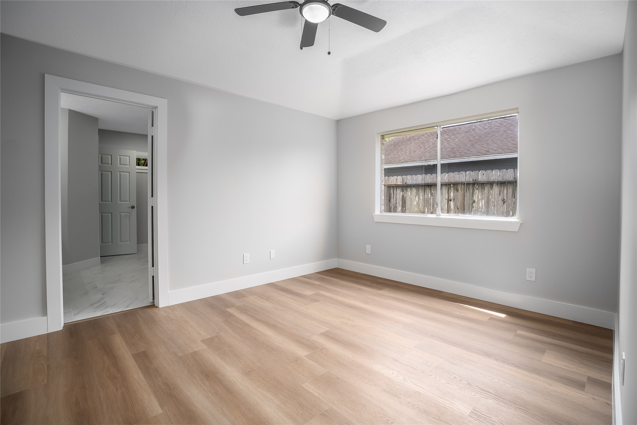1406 Kent Way Friendswood, TX 77546 - Photo 15 of 31 wooden floor in an empty room with a window
