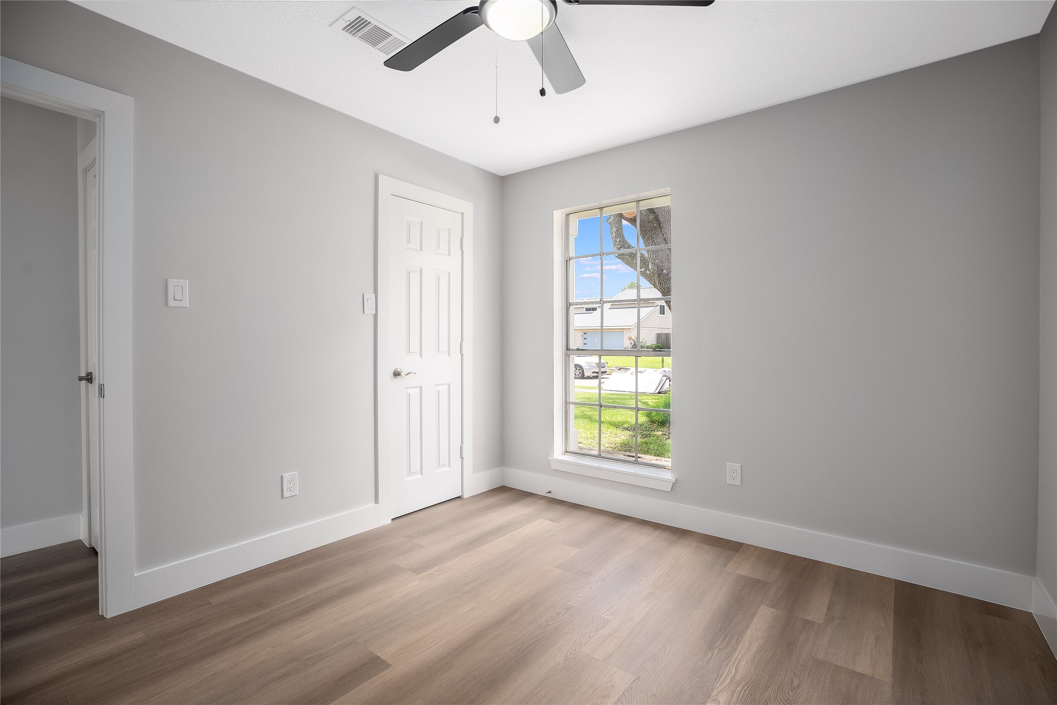 1406 Kent Way Friendswood, TX 77546 - Photo 21 of 31 wooden floor in an empty room with a window