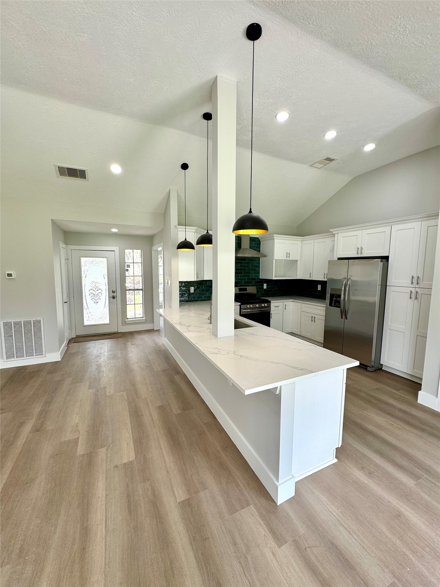 1406 Kent Way Friendswood, TX 77546 - Photo 30 of 31 a large white kitchen with sink a refrigerator and a stove