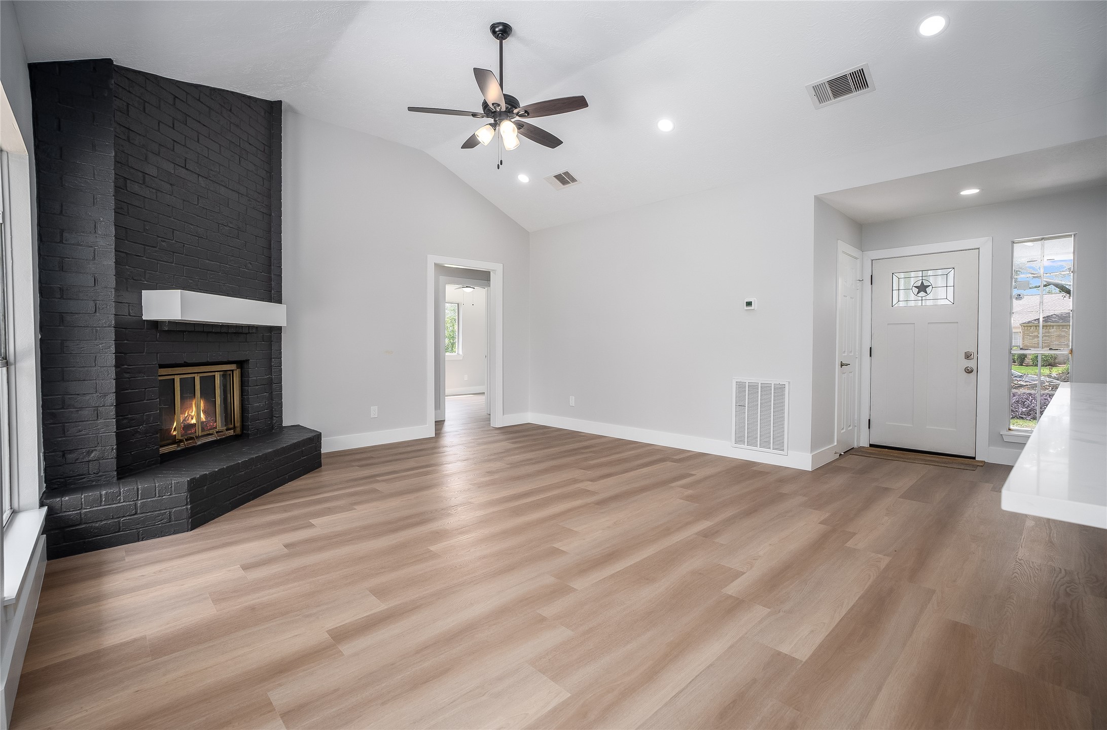 1406 Kent Way Friendswood, TX 77546 - Photo 7 of 31 a view of an empty room with wooden floor and fireplace