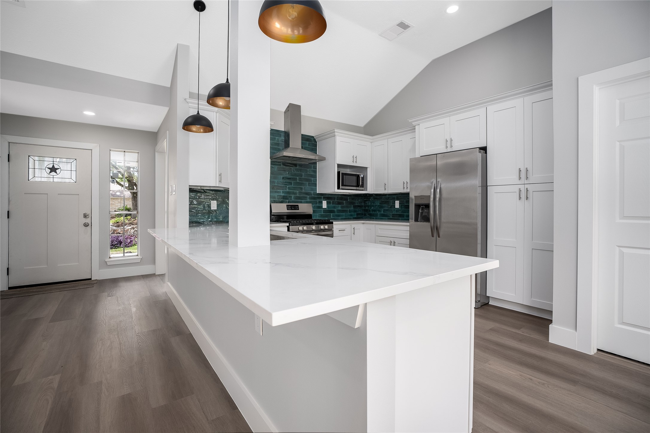 1406 Kent Way Friendswood, TX 77546 - Photo 9 of 31 a kitchen with stainless steel appliances a refrigerator and a stove top oven