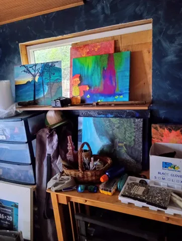 a room with stainless steel appliances and wooden floor