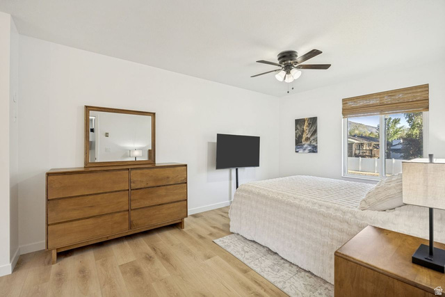 1723 Albury Road Sandy, UT 84092 - Photo 9 of 23 Bright room featuring wood-finish flooring and a ceiling fan with integrated lighting