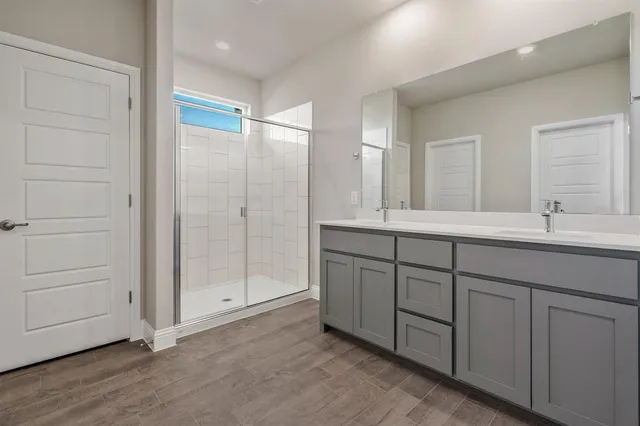 a bathroom with a double vanity sink and a mirror