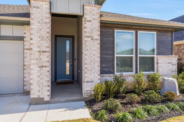 a view of a door of a house with potted plants