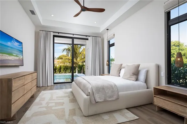 a bedroom with a large bed and a large window