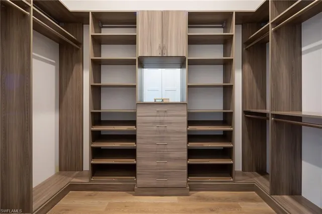 a view of walk in closet with empty racks