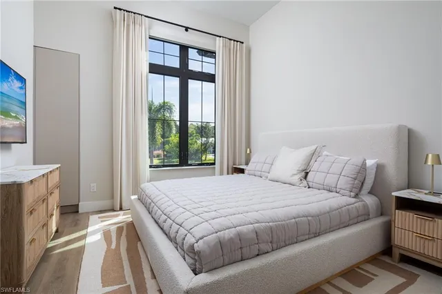 a bed sitting in a bedroom next to a window