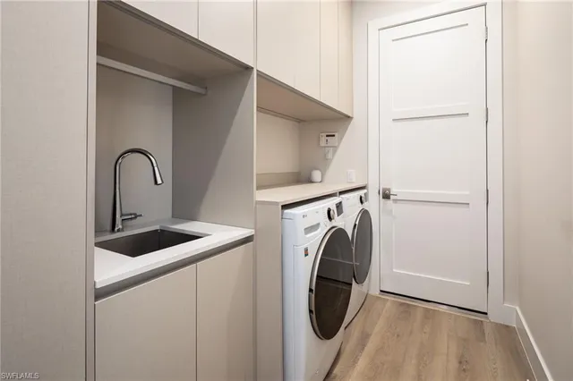 a close view of a sink and washer and dryer