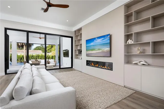 a living room with furniture and a floor to ceiling window