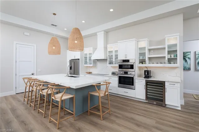 a kitchen with a table chairs microwave and cabinets