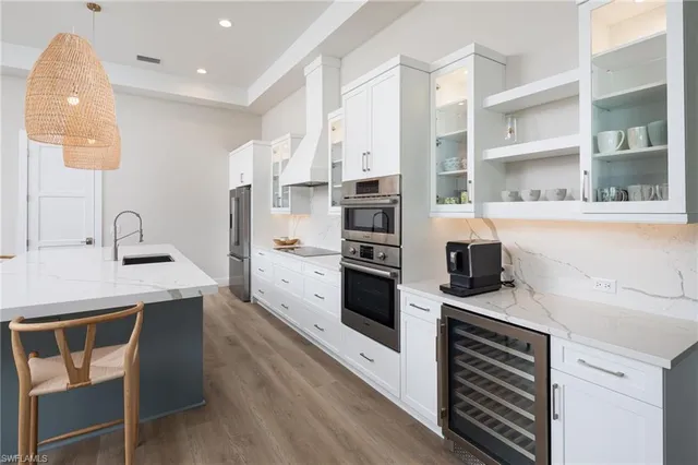 a kitchen with a sink a stove and cabinets