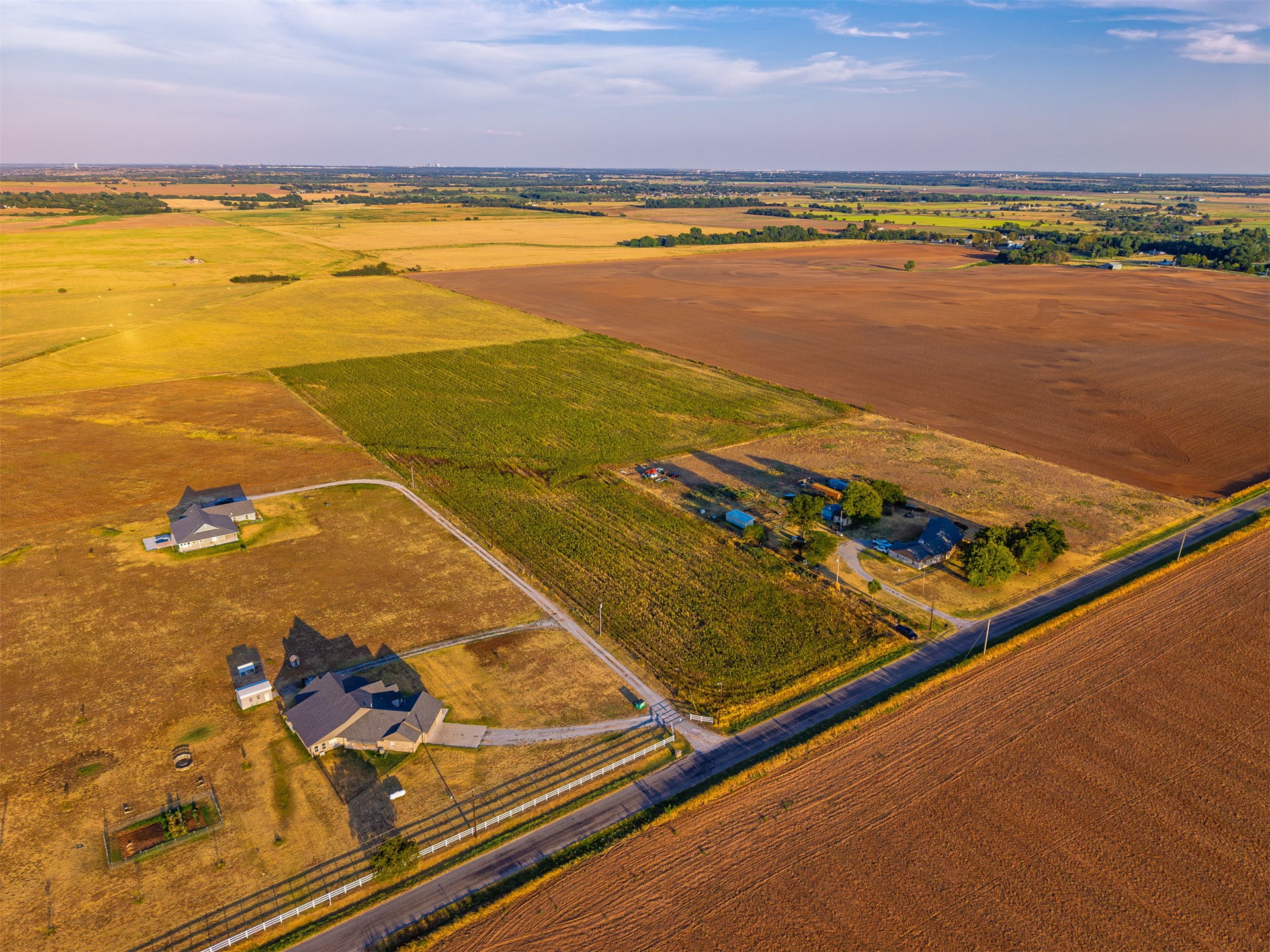 16 North Gregory Road Yukon, OK 73099 - Photo 11 of 34 Expansive agricultural land featuring multiple cultivated fields and a paved road