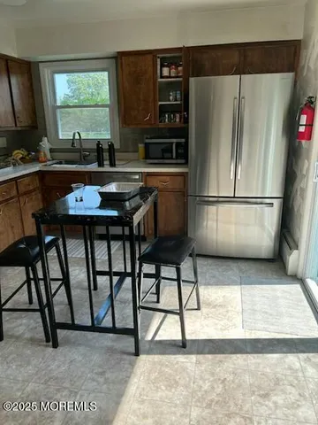 a kitchen with stainless steel appliances granite countertop a refrigerator and a stove top oven