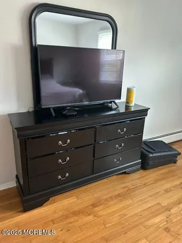 a view of room with wooden floor