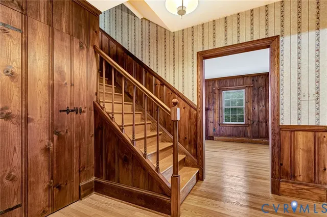 a living room with furniture large window and a fireplace