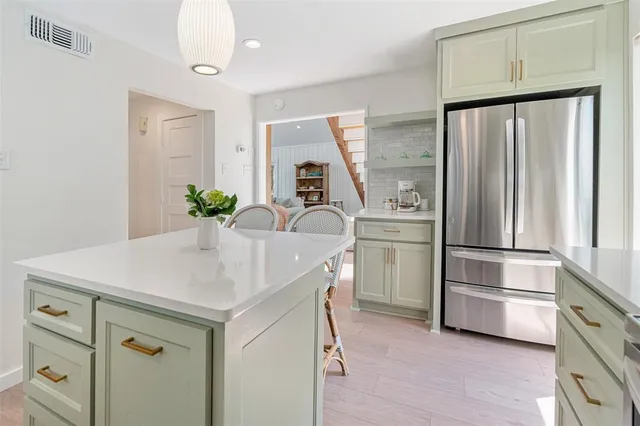 a kitchen with appliances cabinets and furniture