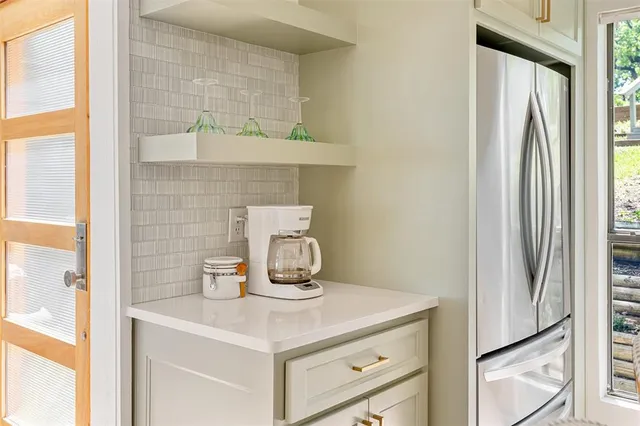 a kitchen with a refrigerator and a stove