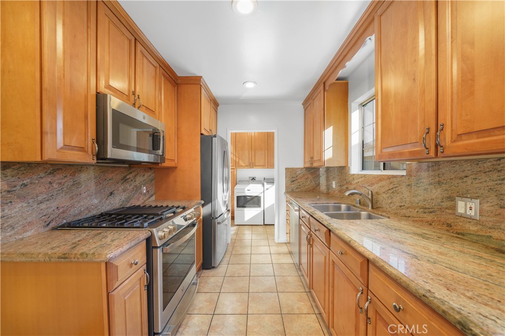 7445 Mammoth Avenue Van Nuys, CA 91405 - Photo 12 of 33 a kitchen with stainless steel appliances a sink stove and cabinets