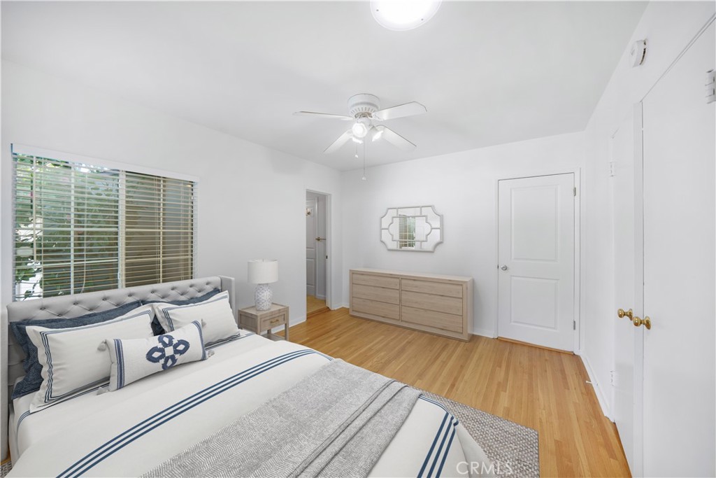 7445 Mammoth Avenue Van Nuys, CA 91405 - Photo 15 of 33 a spacious bedroom with a bed and wooden floor