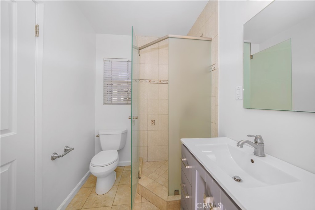 7445 Mammoth Avenue Van Nuys, CA 91405 - Photo 17 of 33 a bathroom with a sink toilet and shower