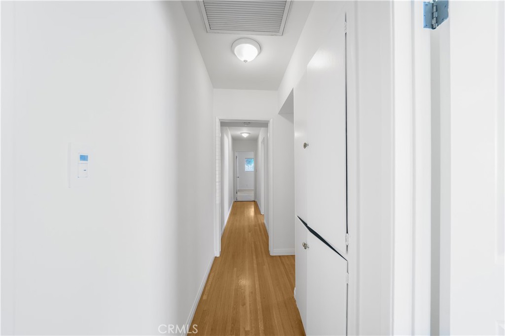 7445 Mammoth Avenue Van Nuys, CA 91405 - Photo 18 of 33 a view of a hallway with wooden floor and a bathroom