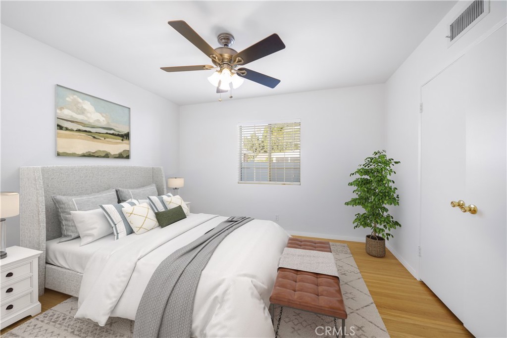 7445 Mammoth Avenue Van Nuys, CA 91405 - Photo 22 of 33 a bedroom with a large bed and a chandelier