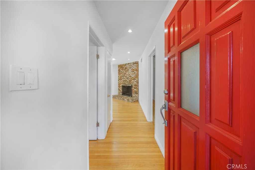 7445 Mammoth Avenue Van Nuys, CA 91405 - Photo 4 of 33 a view of a hallway with wooden shelves