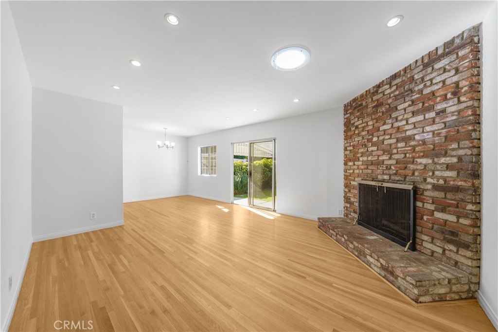7445 Mammoth Avenue Van Nuys, CA 91405 - Photo 6 of 33 a view of empty room with wooden floor and fireplace