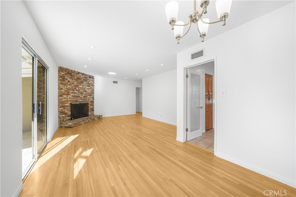 7445 Mammoth Avenue Van Nuys, CA 91405 - Photo 8 of 33 a view of a livingroom with wooden floor and staircase