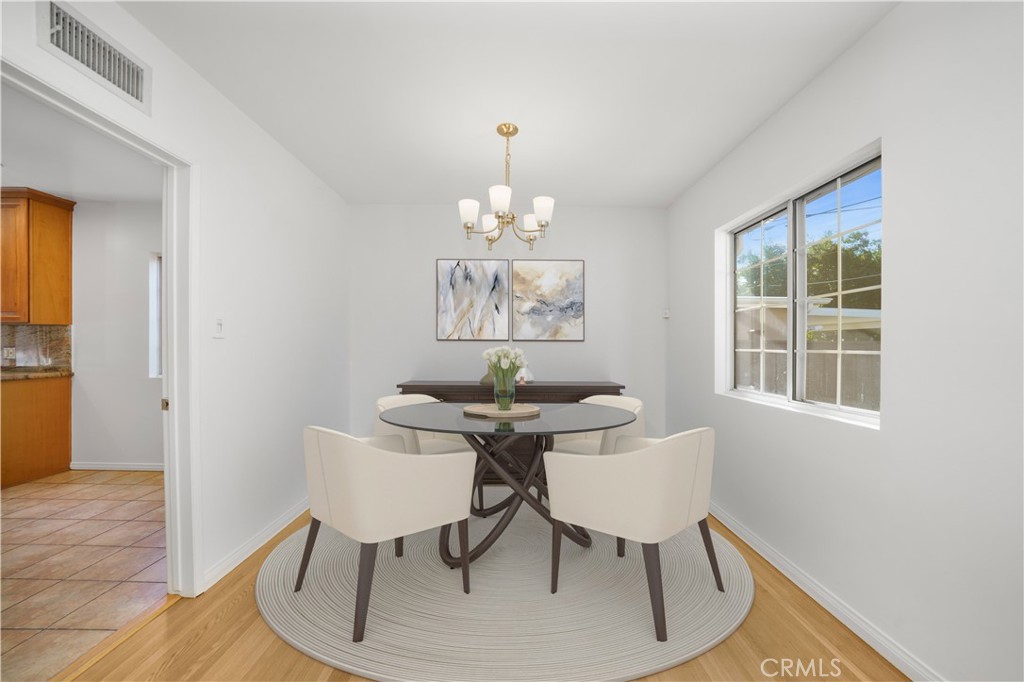 7445 Mammoth Avenue Van Nuys, CA 91405 - Photo 9 of 33 a view of a dining room with furniture wooden floor and chandelier
