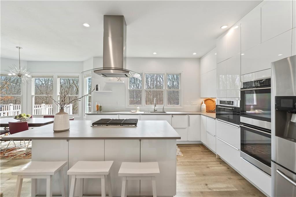 233 Crosswinds Court Coraopolis, PA 15108 - Photo 3 of 49 The stunning European -style updated kitchen boasts sleek, frameless white glass cabinetry with clean, modern lines that maximize both space and style.
