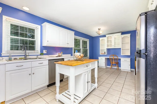 a kitchen with granite countertop a sink stove and cabinets