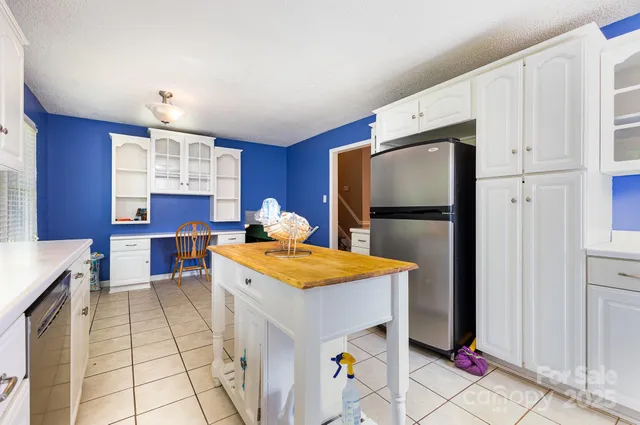 a kitchen with a sink a stove a refrigerator and cabinets