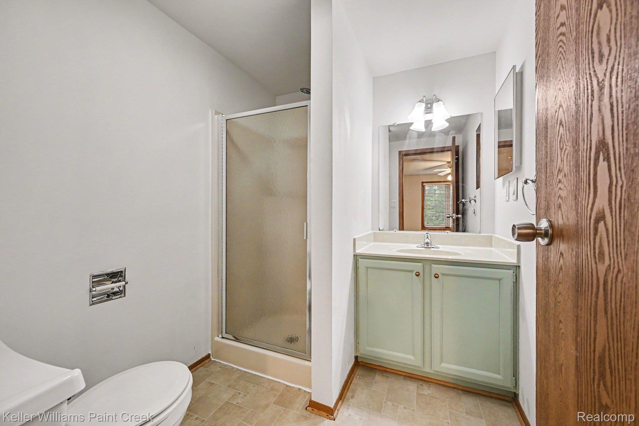 2232 London Bridge Drive Rochester, MI 48307 - Photo 23 of 26 Vanity with integrated sink, light-colored countertop, and storage cabinetry