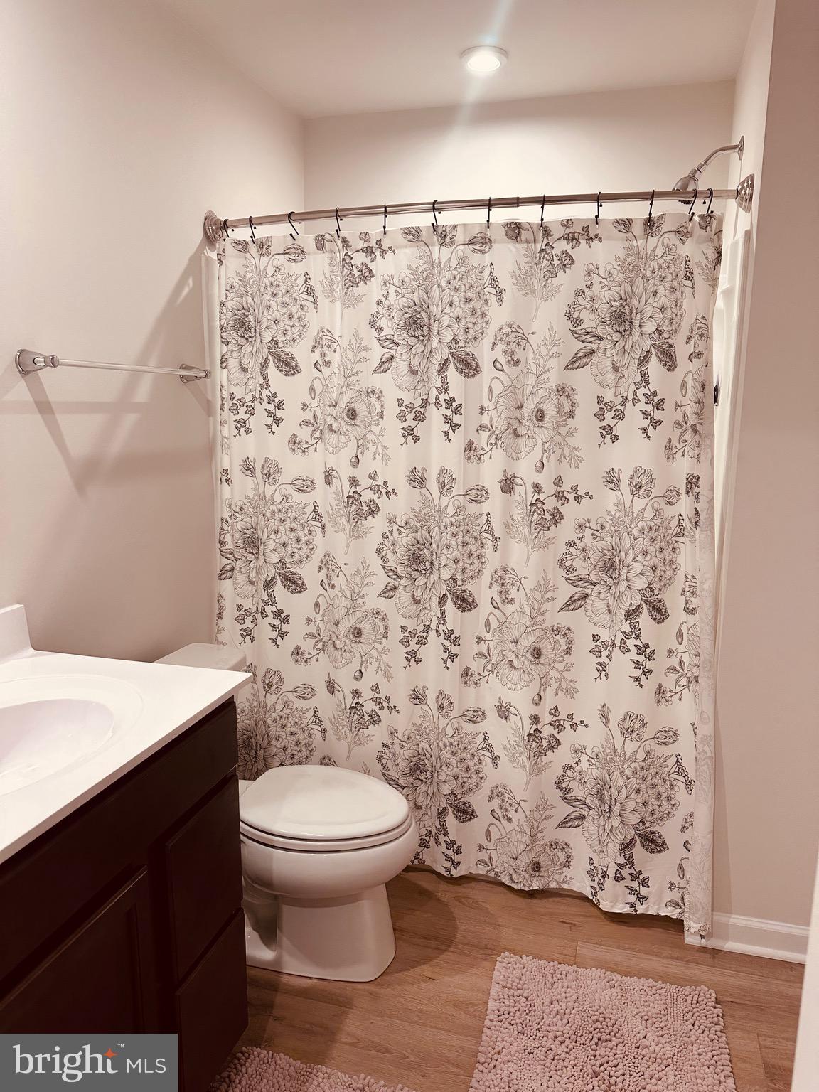309 Yellow Bill Lane, Unit JUNIPER Cambridge, MD 21613 - Photo 17 of 25 a bathroom with a toilet and a shower curtain