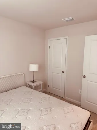 a bedroom with a bed and a lamp