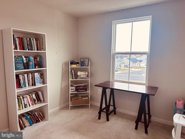a view of a workspace with a bookshelf