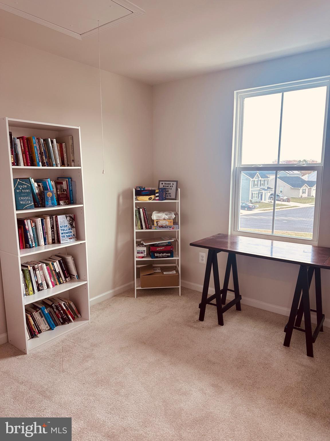 309 Yellow Bill Lane, Unit JUNIPER Cambridge, MD 21613 - Photo 23 of 25 a view of a workspace with furniture and a bookshelf
