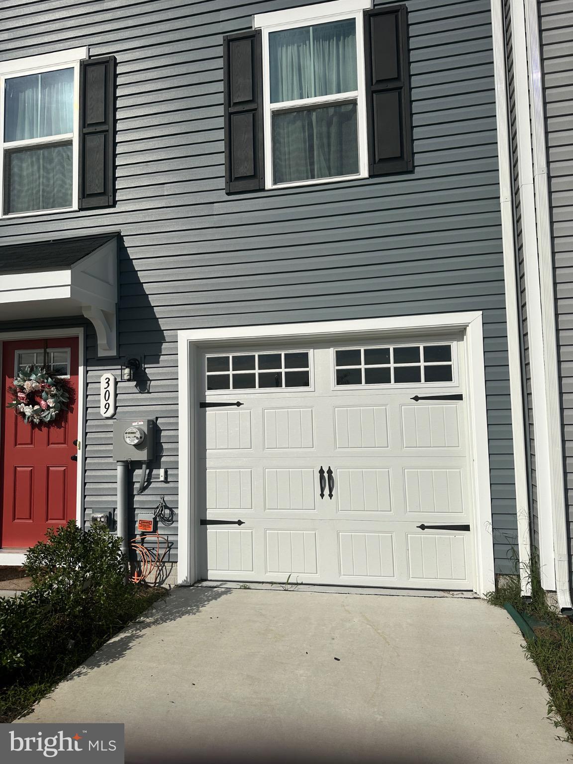 309 Yellow Bill Lane, Unit JUNIPER Cambridge, MD 21613 - Photo 3 of 25 a front view of a house with a yard and garage