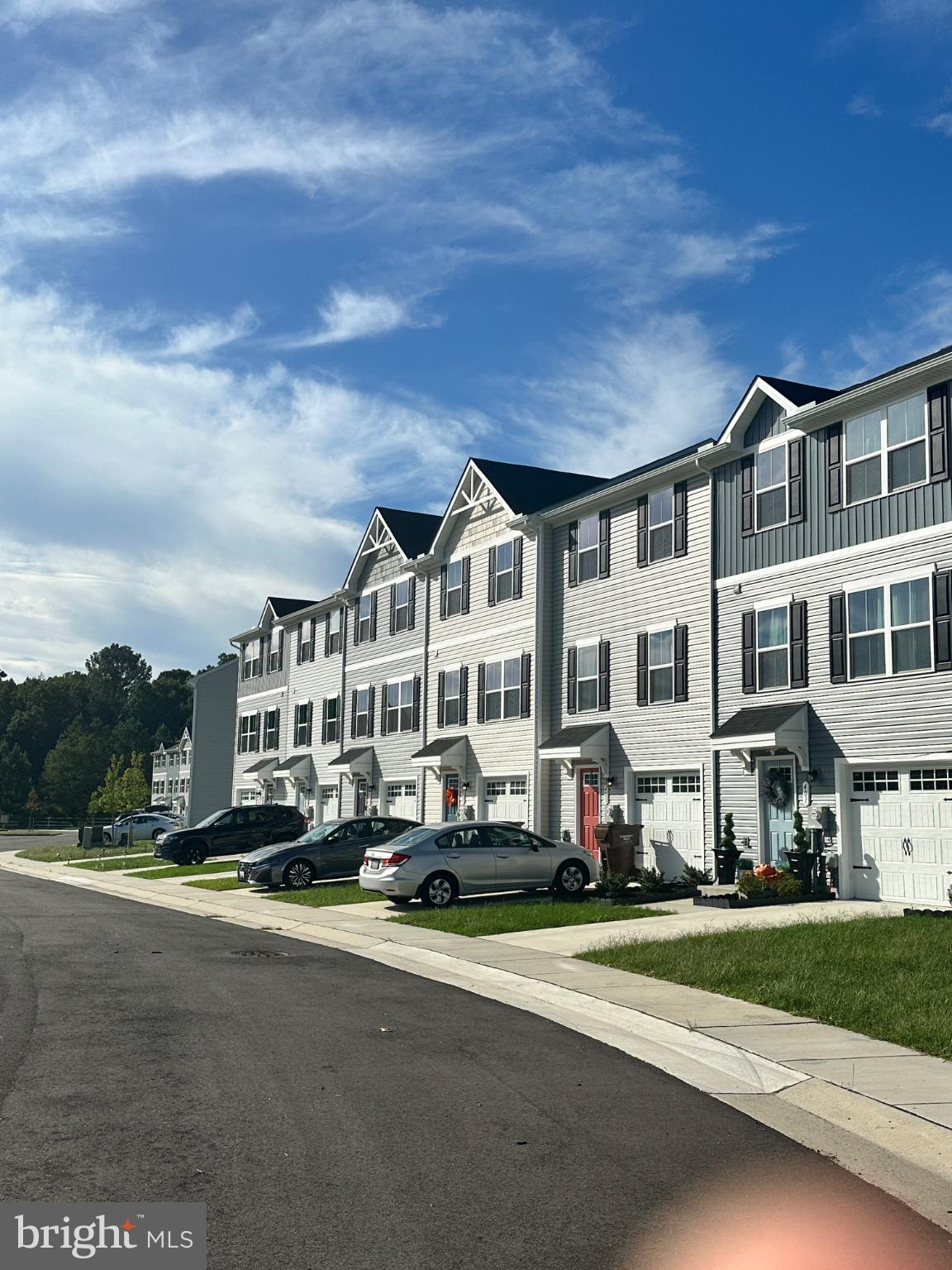 309 Yellow Bill Lane, Unit JUNIPER Cambridge, MD 21613 - Photo 4 of 25 a front view of residential houses with yard and trees