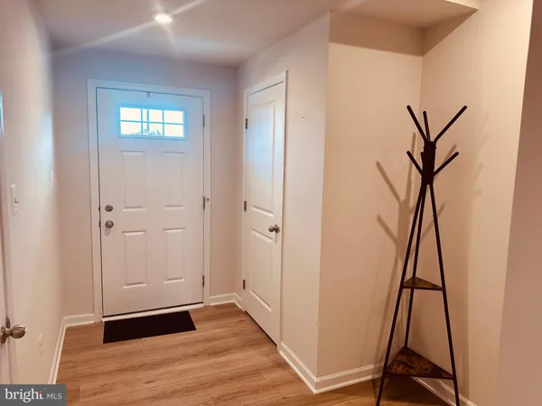 a view of an entryway with wooden floor