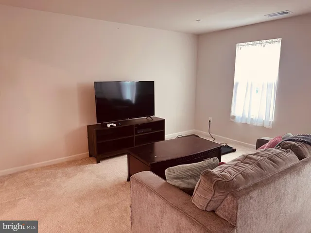 a bedroom with bed and a flat screen tv